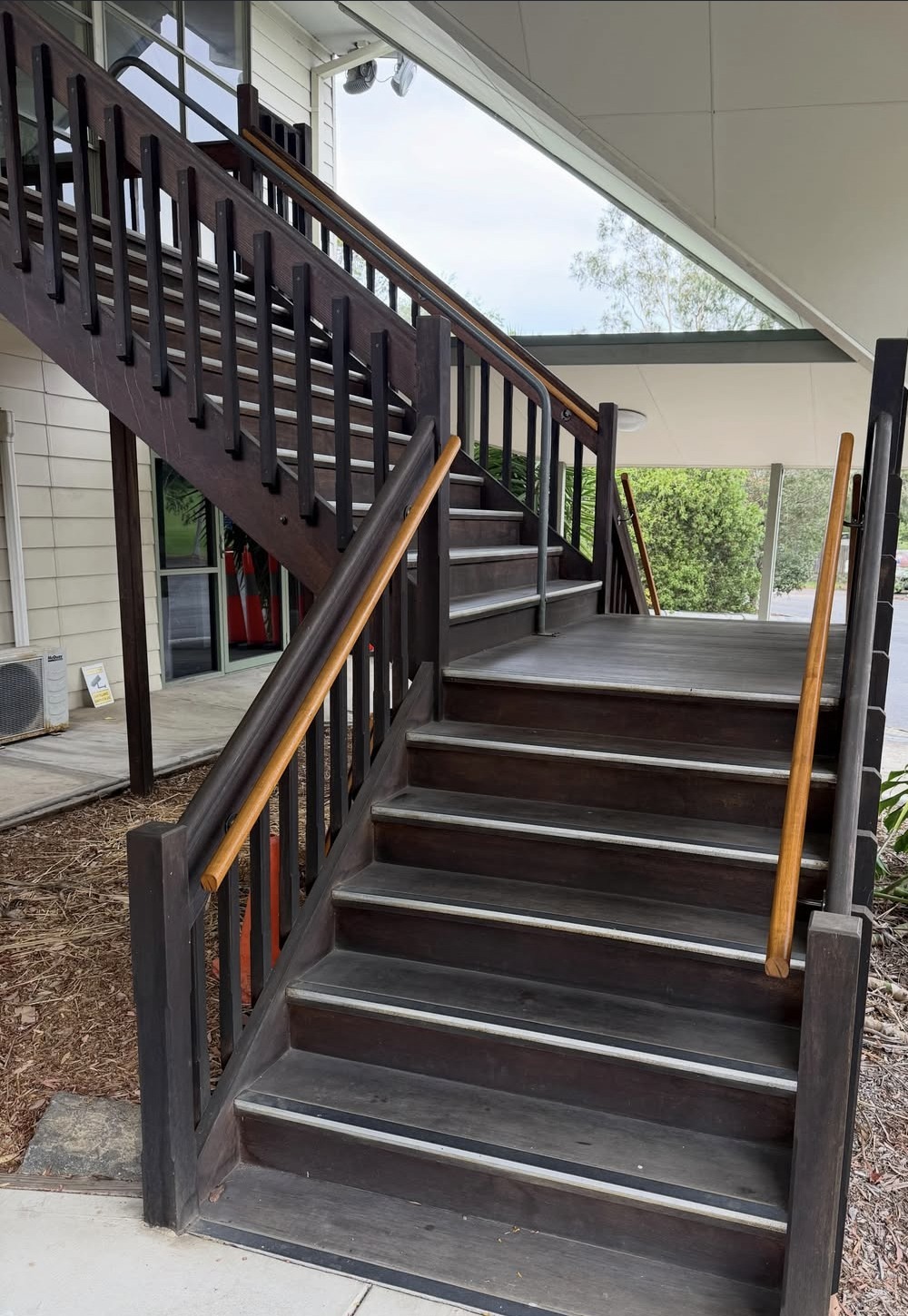 Finished timber handrails beside an outdoor staircase